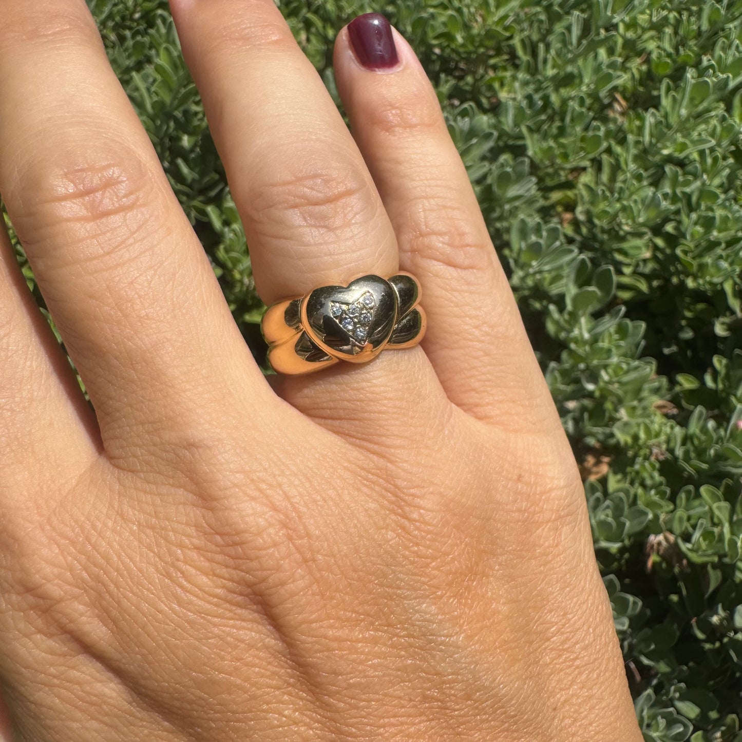 18K gold ring featuring a bold heart design, set with sparkling Diamonds in the center.