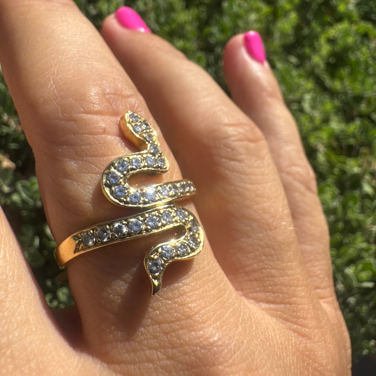 18K gold snake ring adorned with sparkling Diamonds, elegantly wrapping around the finger.