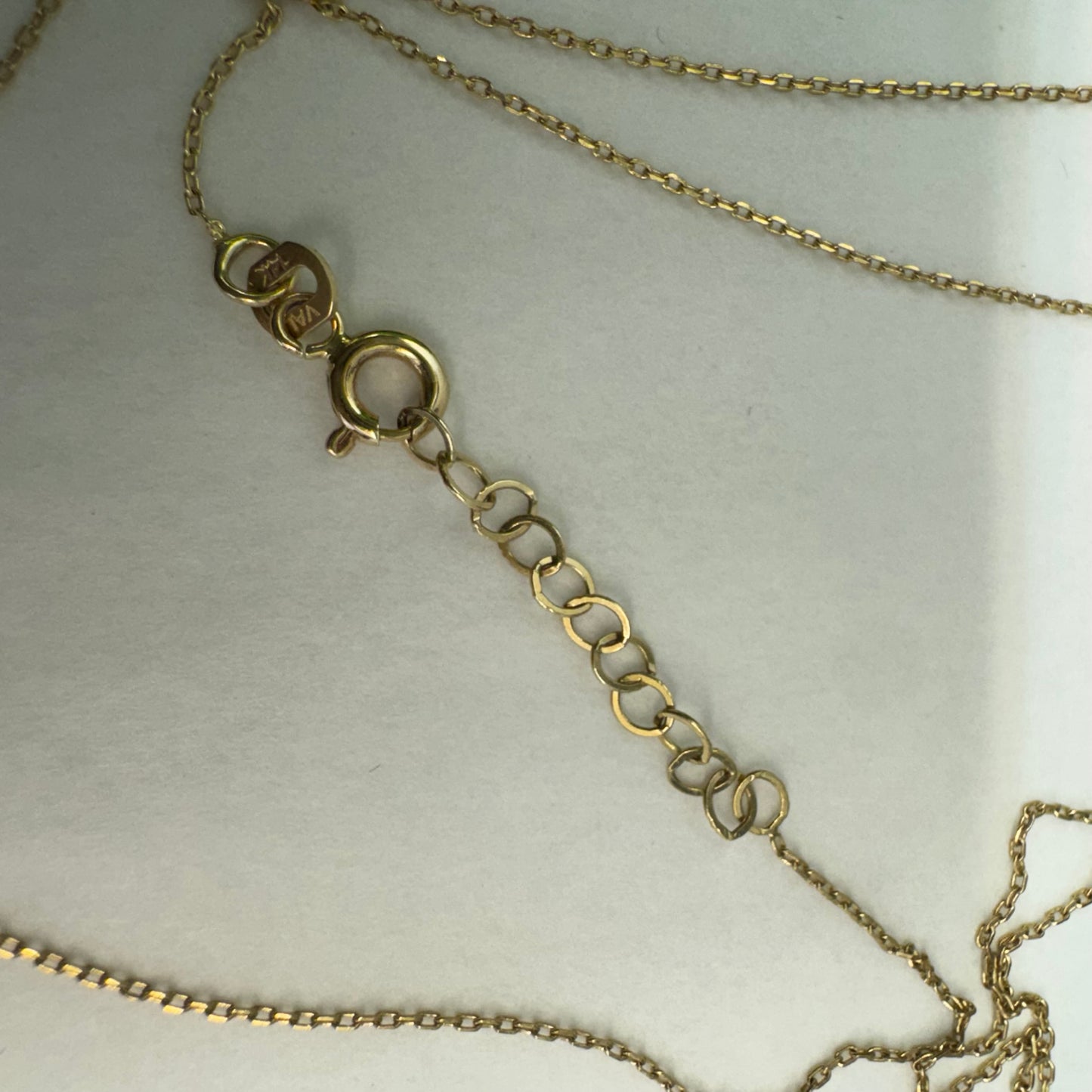 14K gold necklace featuring a heart-shaped pendant with a delicate geometric texture