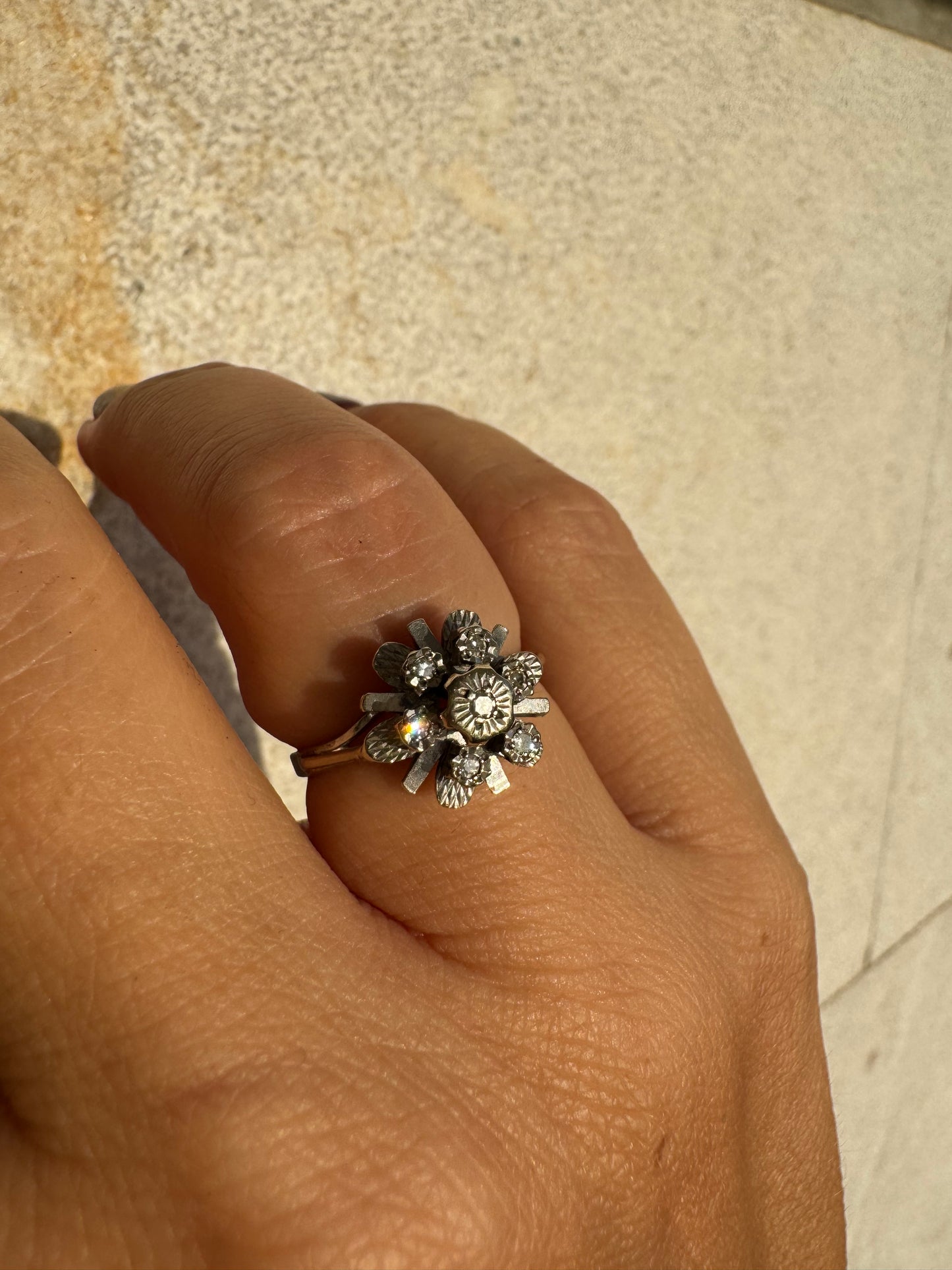 18K gold floral ring adorned with delicate diamond accents