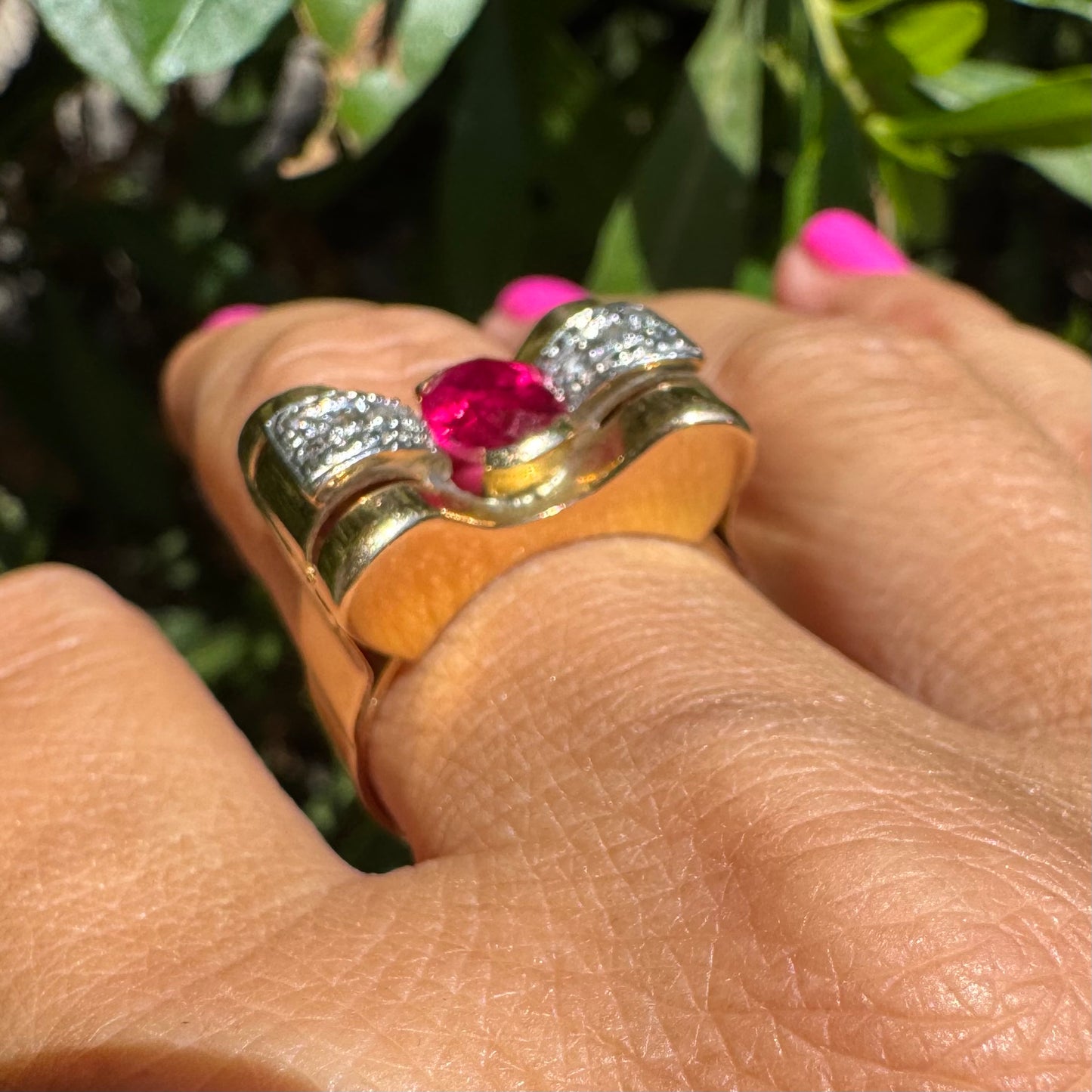 18K gold ring in a sculptural bow-inspired design.
Set with a vivid oval-cut Ruby at the center, framed by shimmering Diamonds