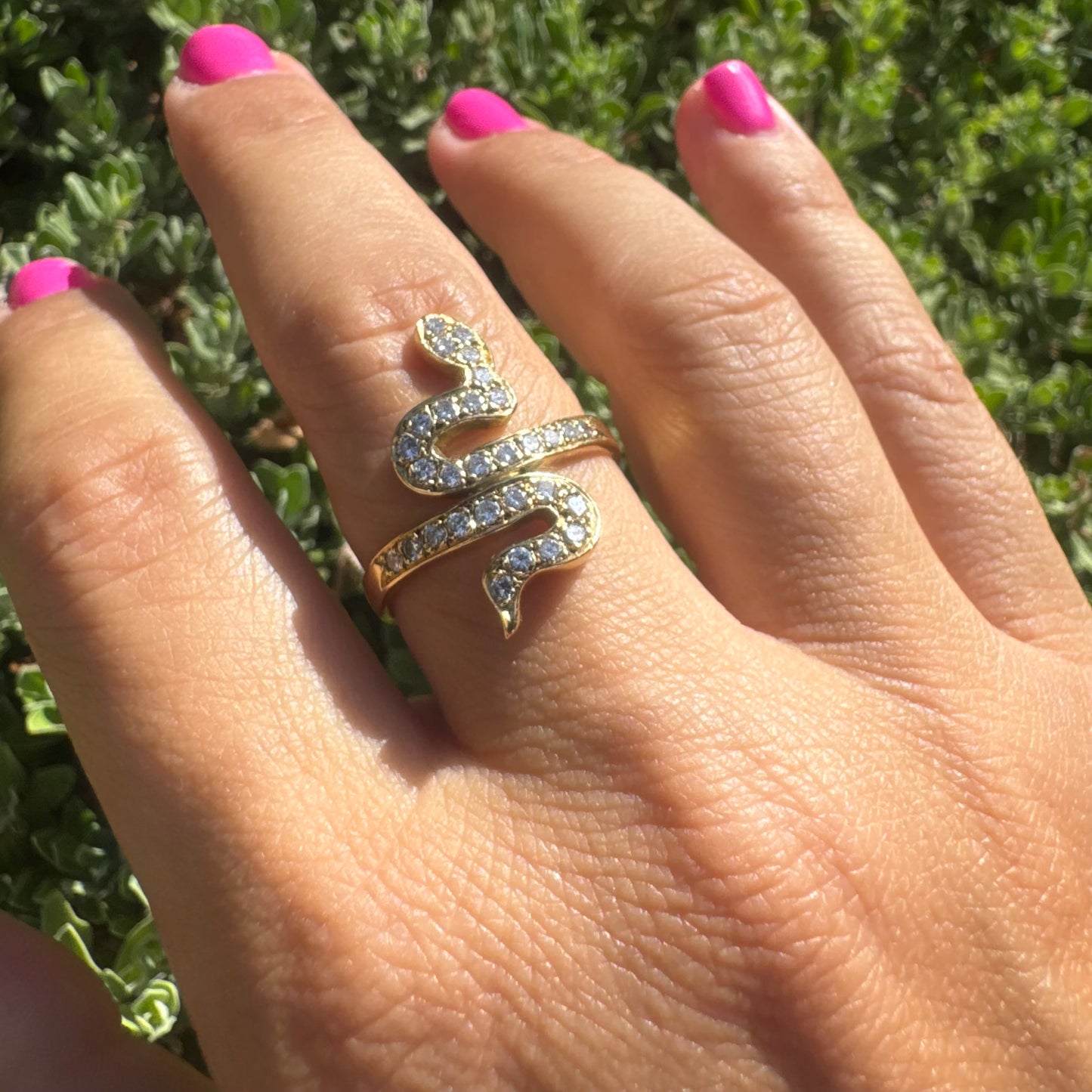 18K gold snake ring adorned with sparkling Diamonds, elegantly wrapping around the finger.