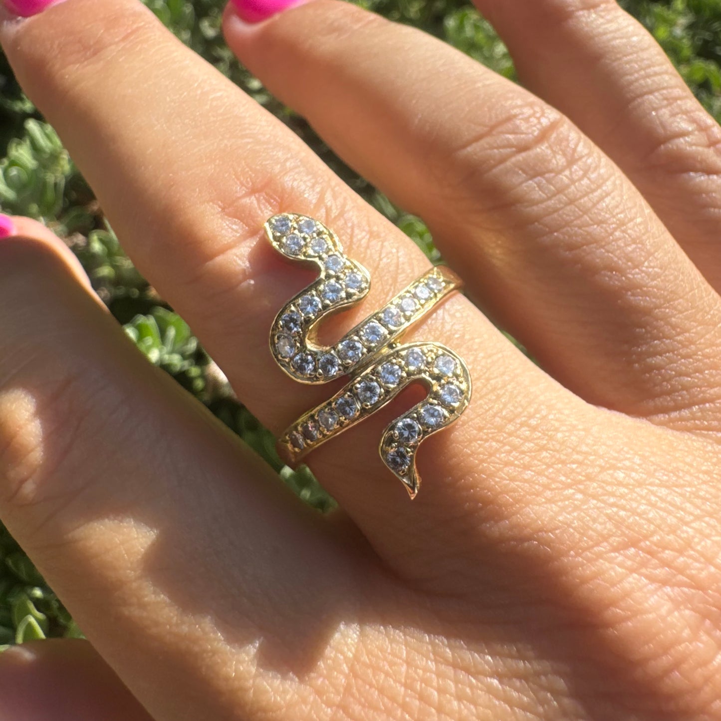 18K gold snake ring adorned with sparkling Diamonds, elegantly wrapping around the finger.