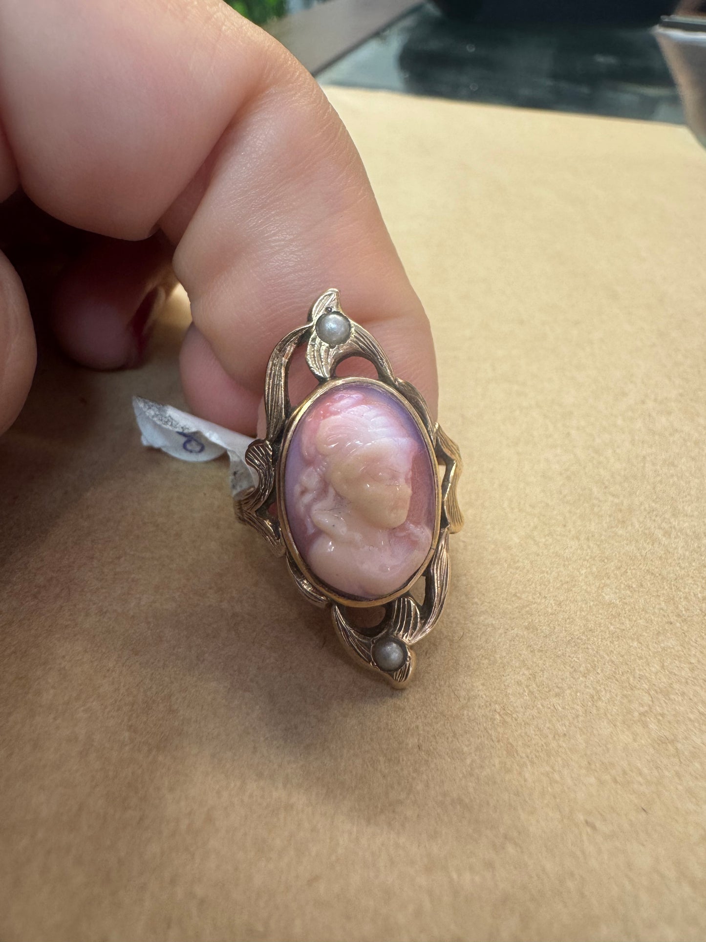 14K gold ring set with a hand-carved pink Cameo, framed by delicate details and accented with small Pearls.