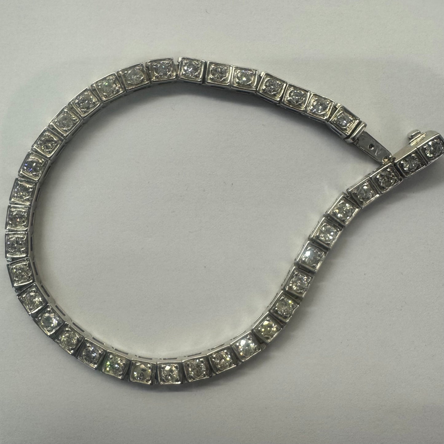 18K gold tennis bracelet set with sparkling round-cut Diamonds in square bezel settings, creating a timeless and sophisticated look.