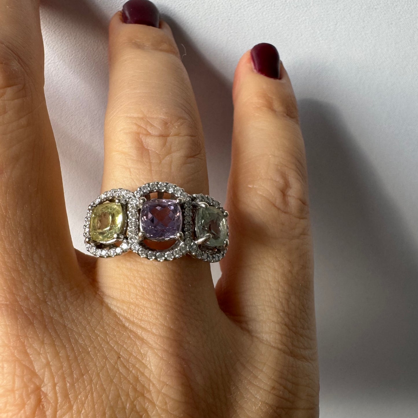 18K gold ring set with three pastel gemstones in soft shades of lilac, yellow and light gray