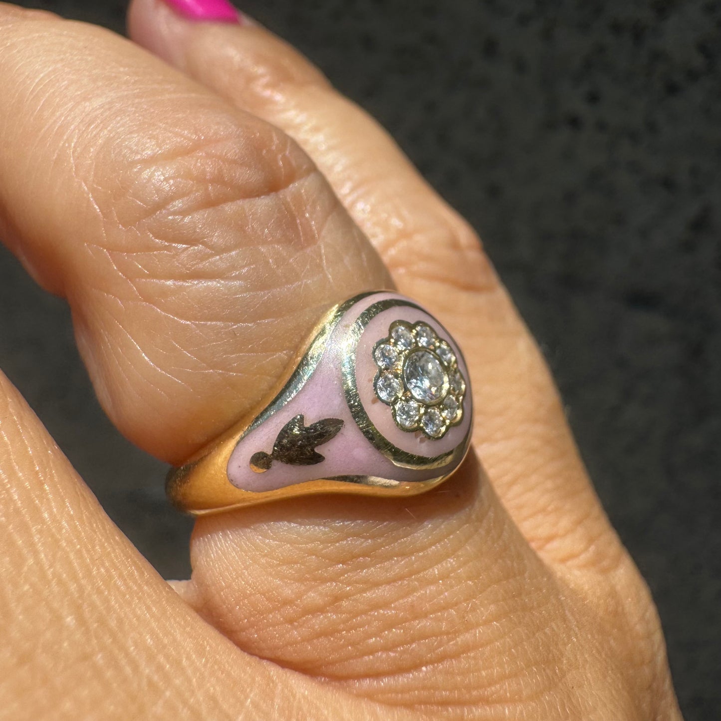 14K gold ring set with soft pink enamel & Diamonds with floral motif at the center.