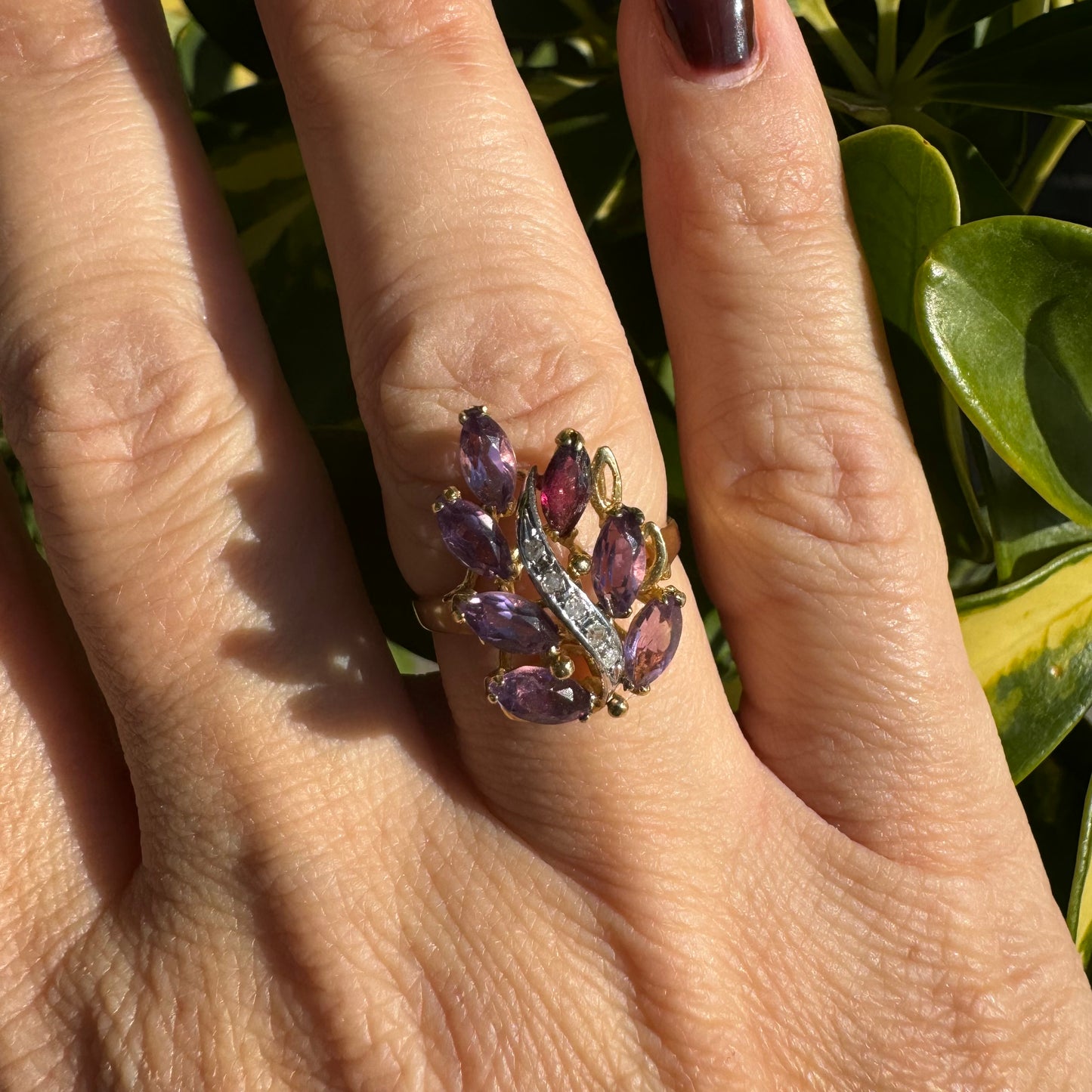 14K gold ring designed in a leaf motif, set with 7 marquise-cut Amethyst and accented by a curved line of sparkling Diamonds