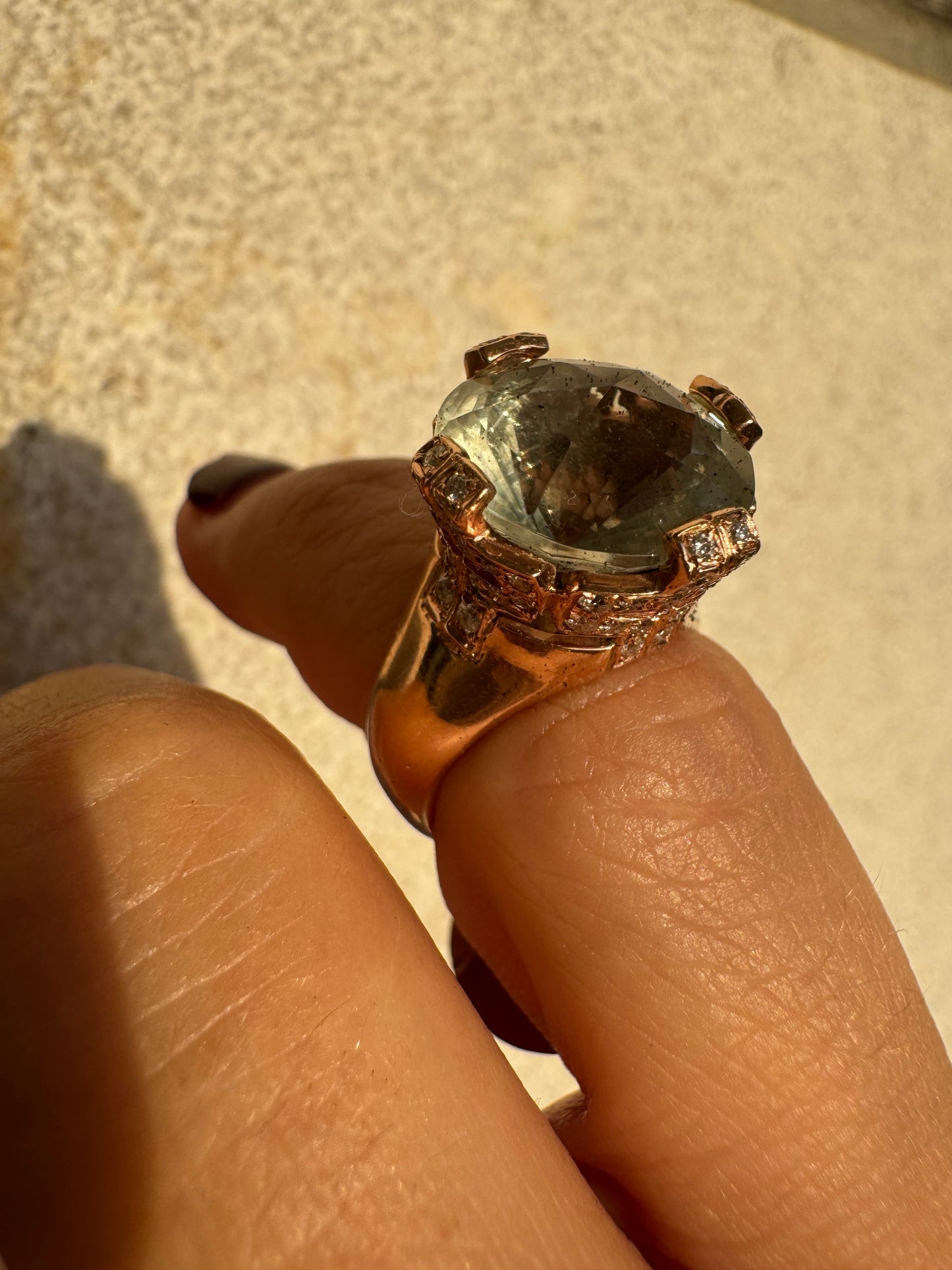 18K gold ring set with a large round Prasiolite gemstone accented by small Diamonds
