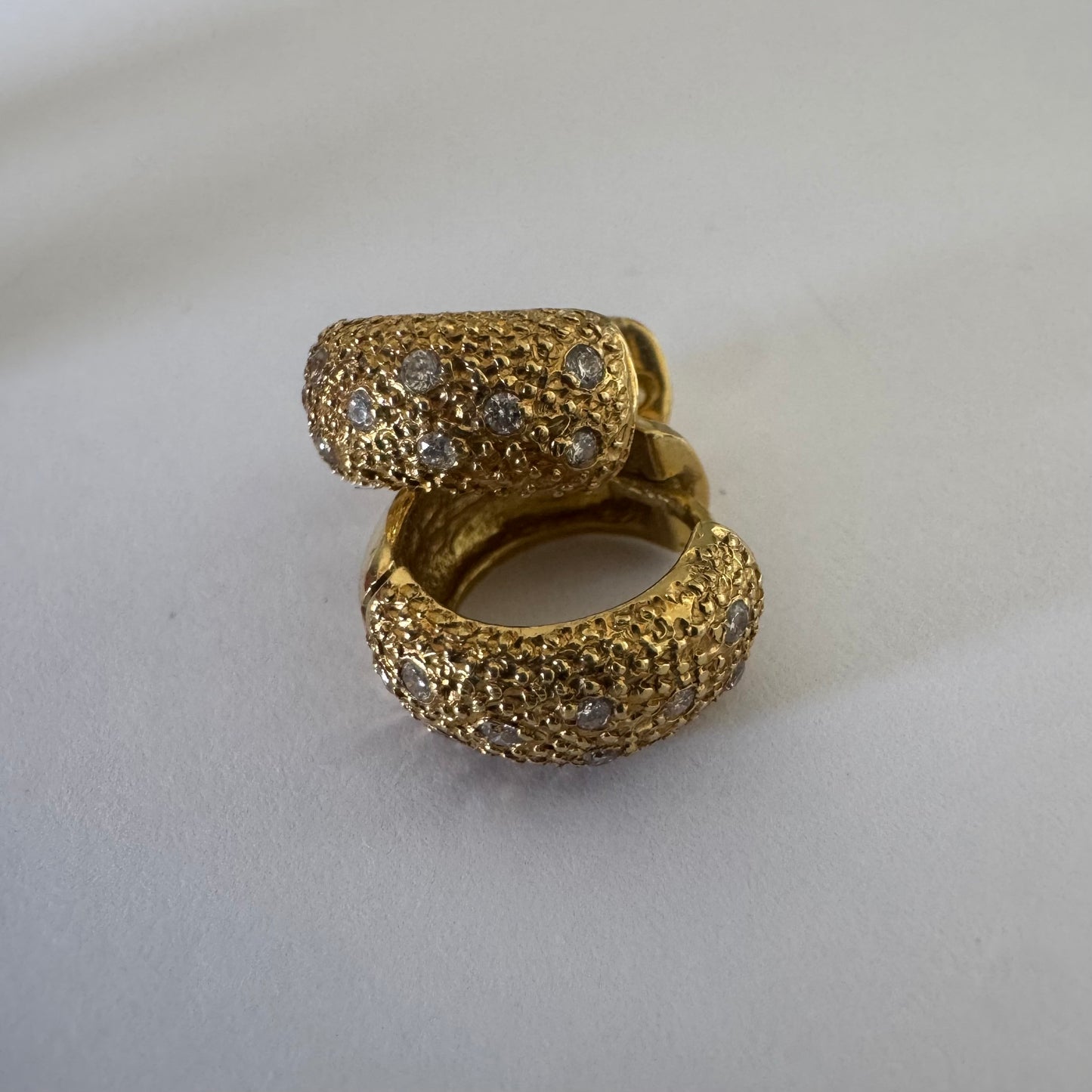 18K gold hoop earrings designed with a rich organic texture and set with Diamonds