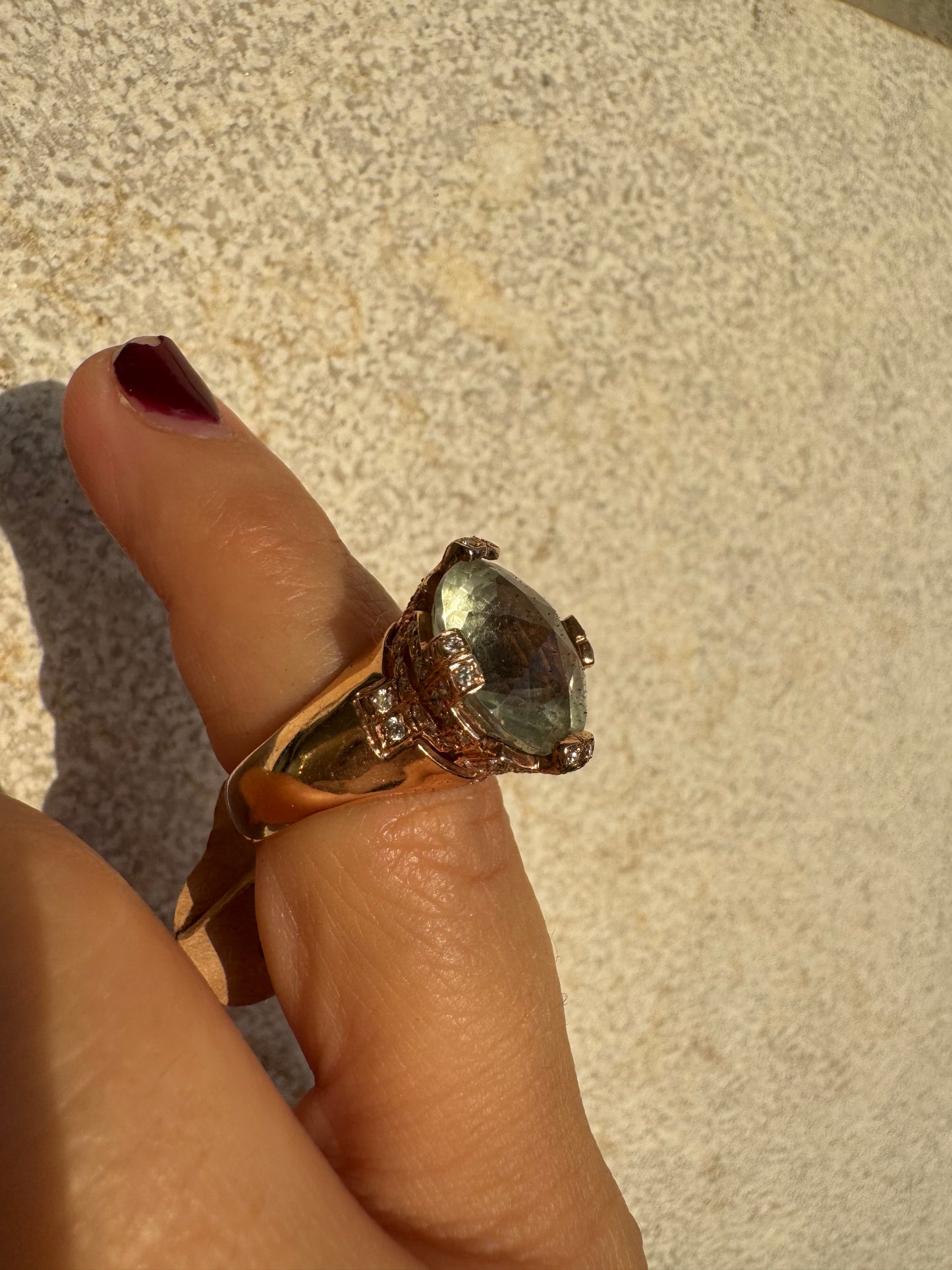 18K gold ring set with a large round Prasiolite gemstone accented by small Diamonds