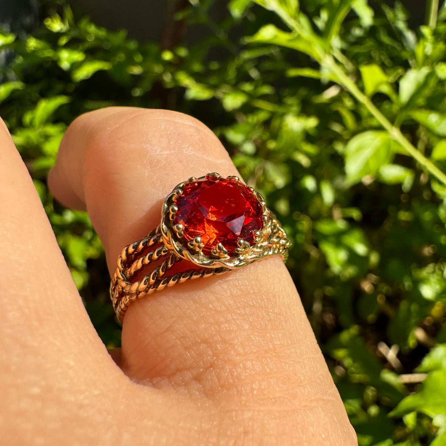 10K gold ring set with a vivid orange gemstone