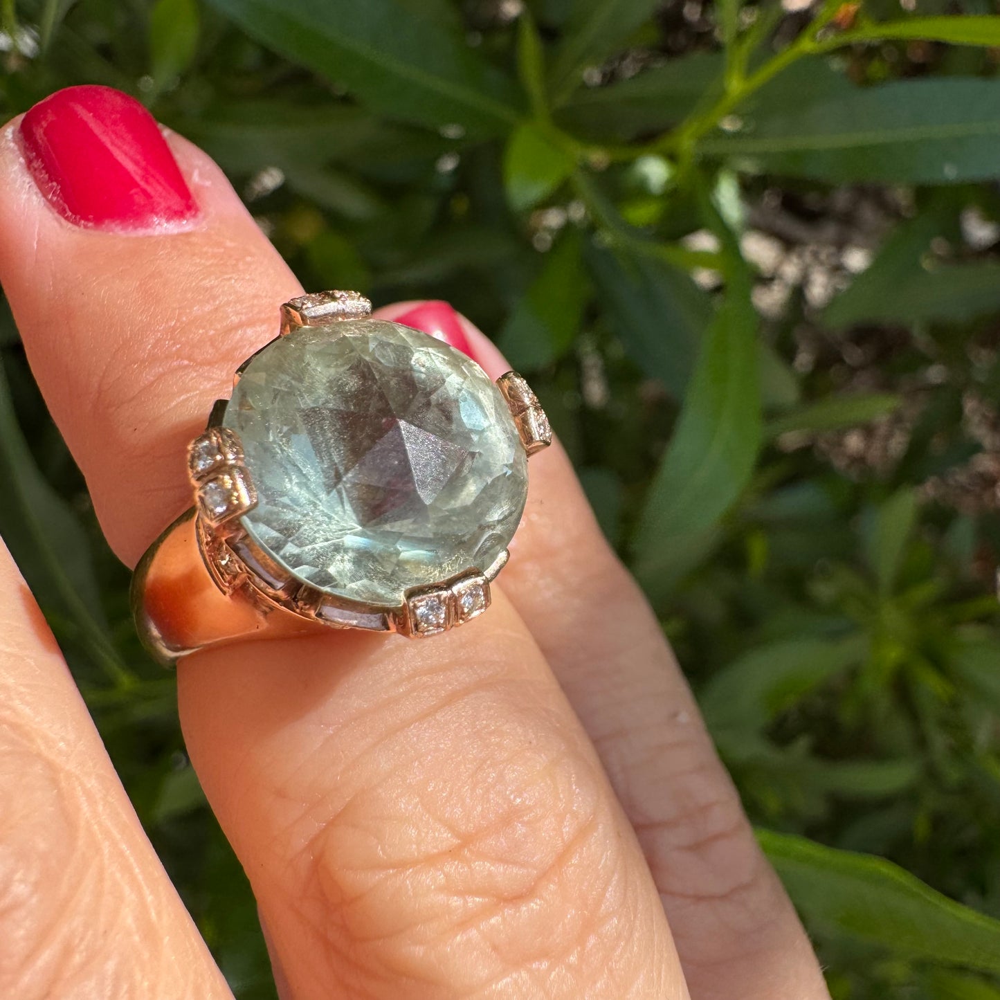 18K gold ring set with a large round Prasiolite gemstone accented by small Diamonds