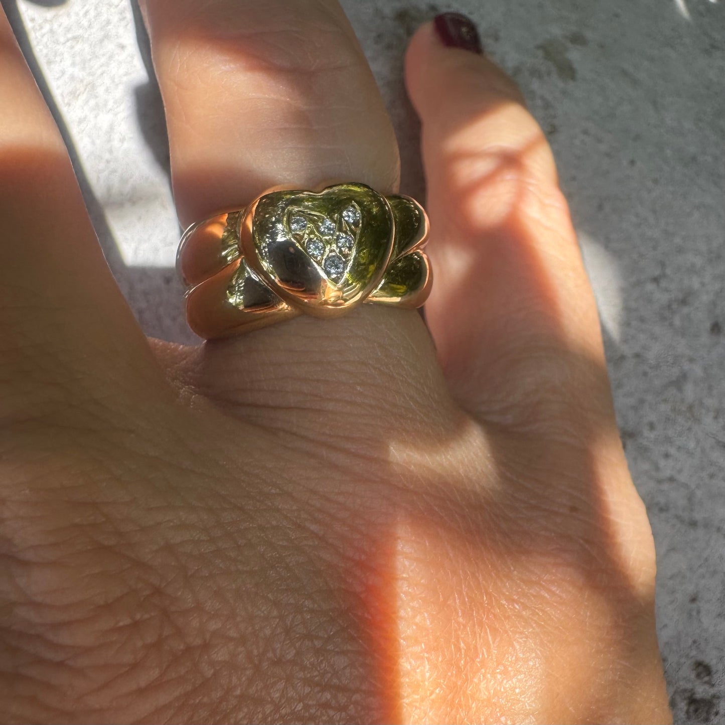 18K gold ring featuring a bold heart design, set with sparkling Diamonds in the center.
