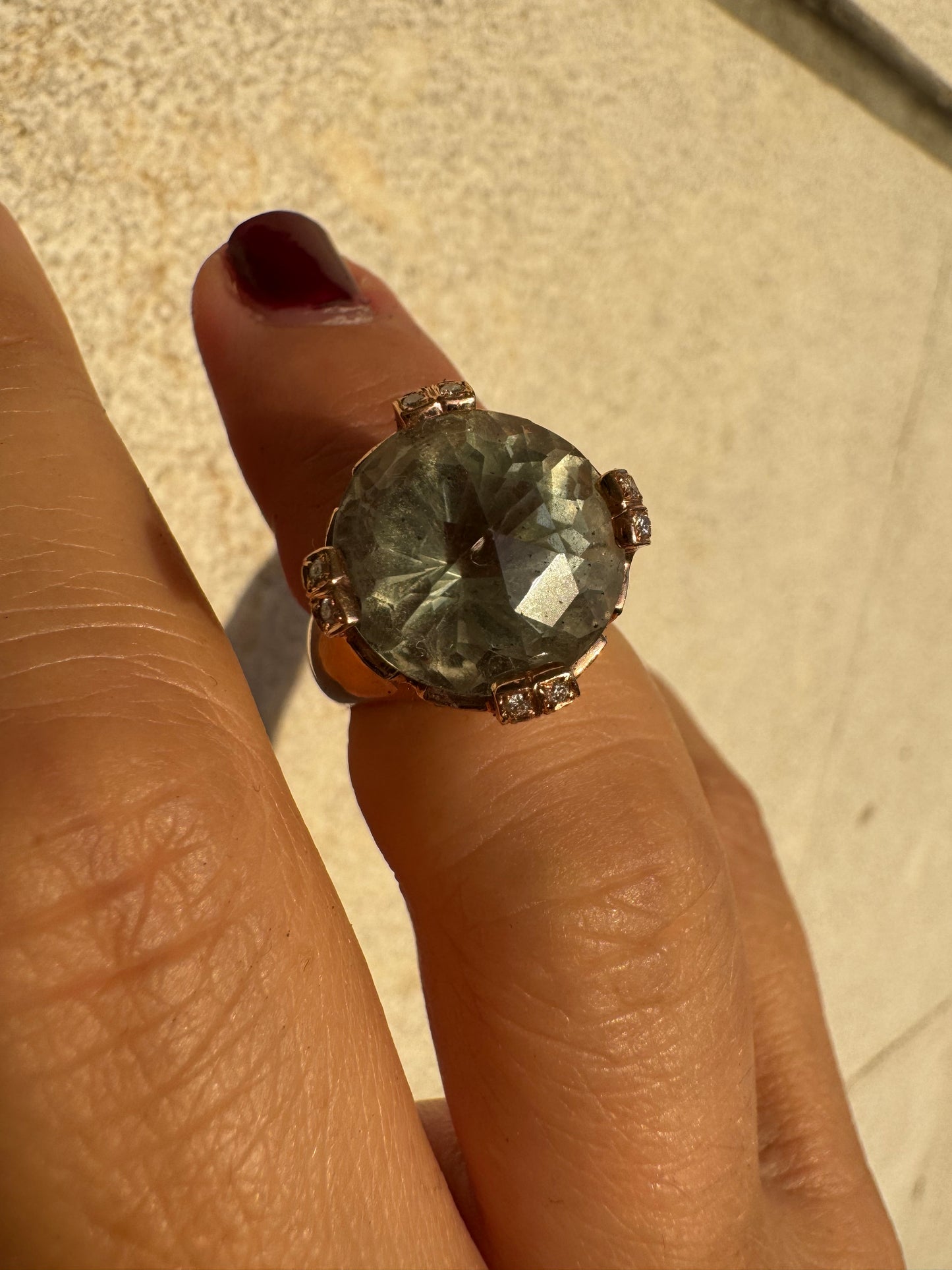 18K gold ring set with a large round Prasiolite gemstone accented by small Diamonds