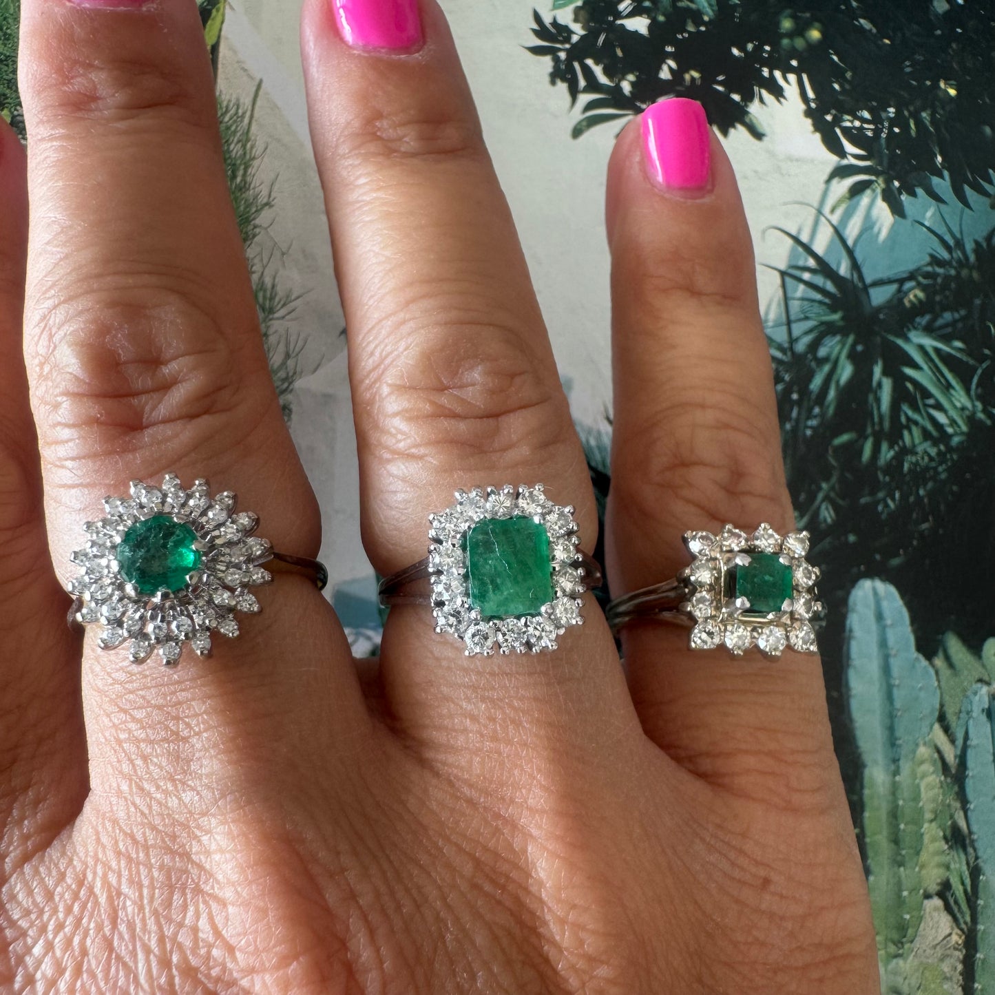 18K gold ring set with a vibrant square-cut Emerald surrounded by a sparkling halo of Diamonds.