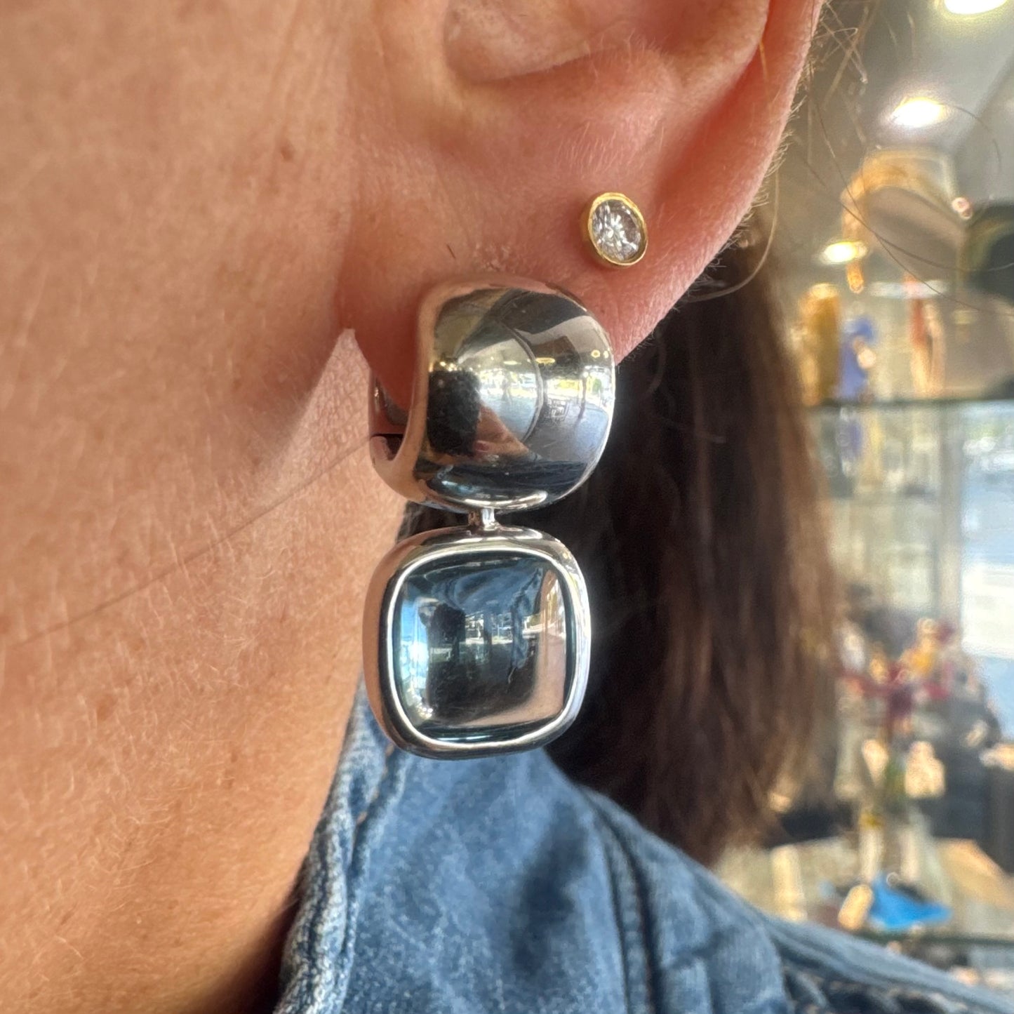 18K gold drop earrings featuring cushion-shaped Aquamarine in a smooth bezel setting, with a polished, modern design.