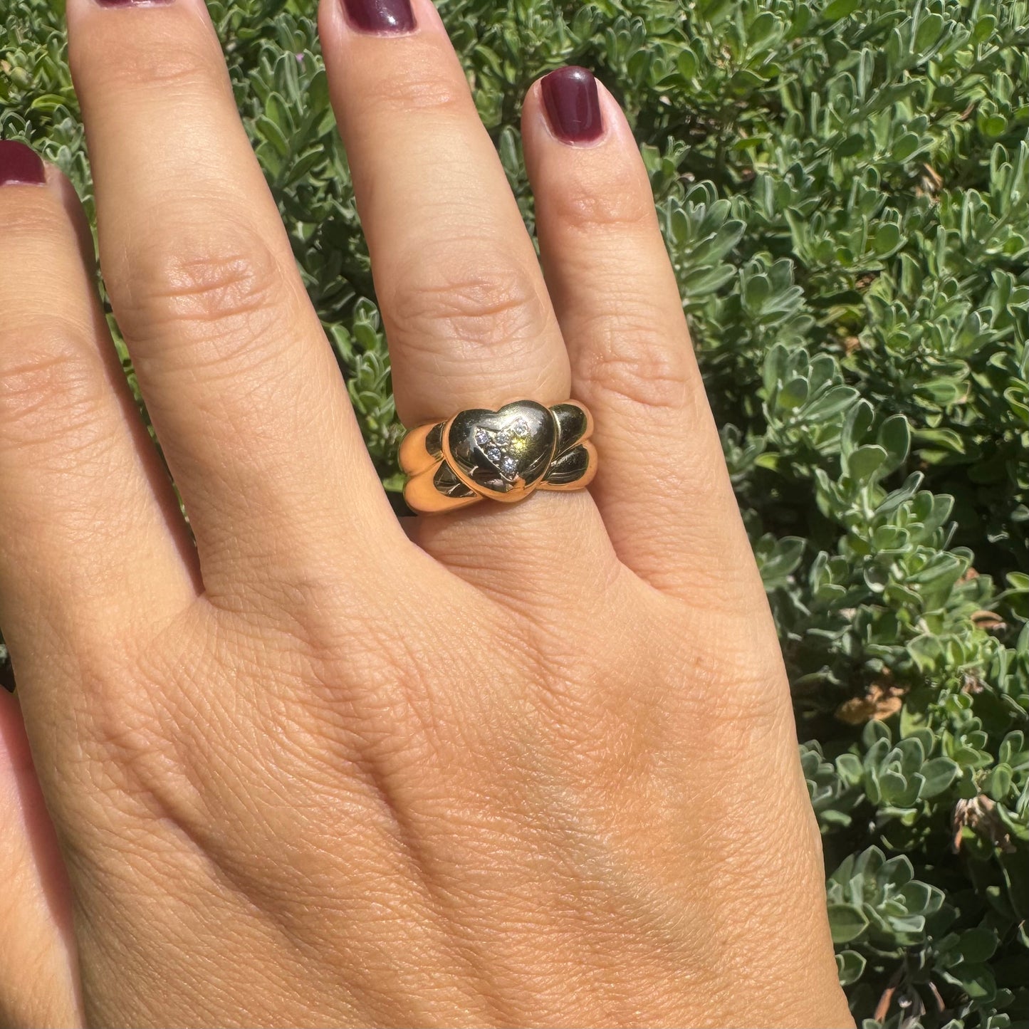 18K gold ring featuring a bold heart design, set with sparkling Diamonds in the center.