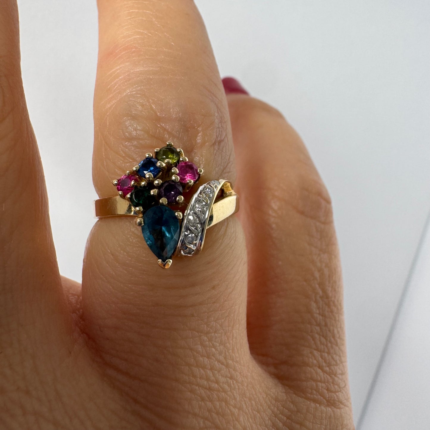 14K gold ring set with a mix of colorful gemstones and Diamonds in a unique design.