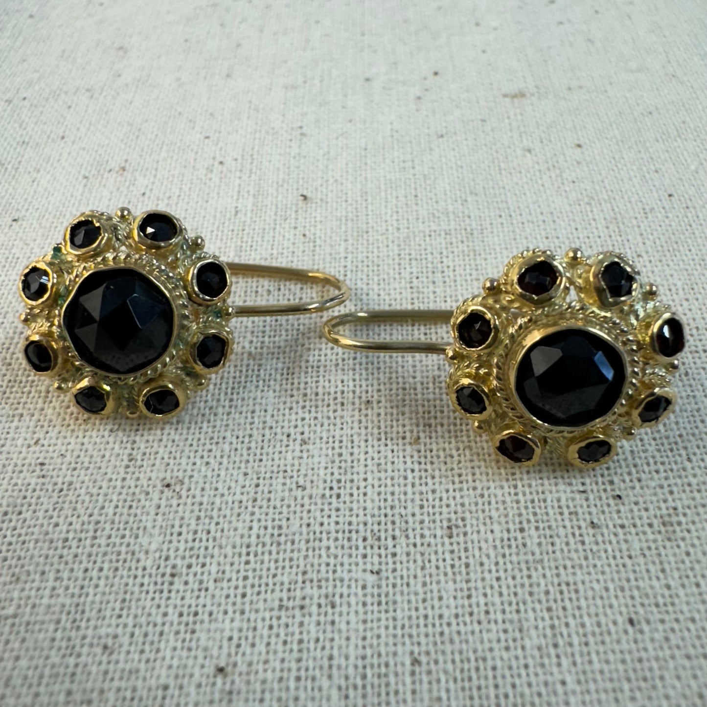 14K gold drop earrings set with deep red Garnets arranged in a bold circular design