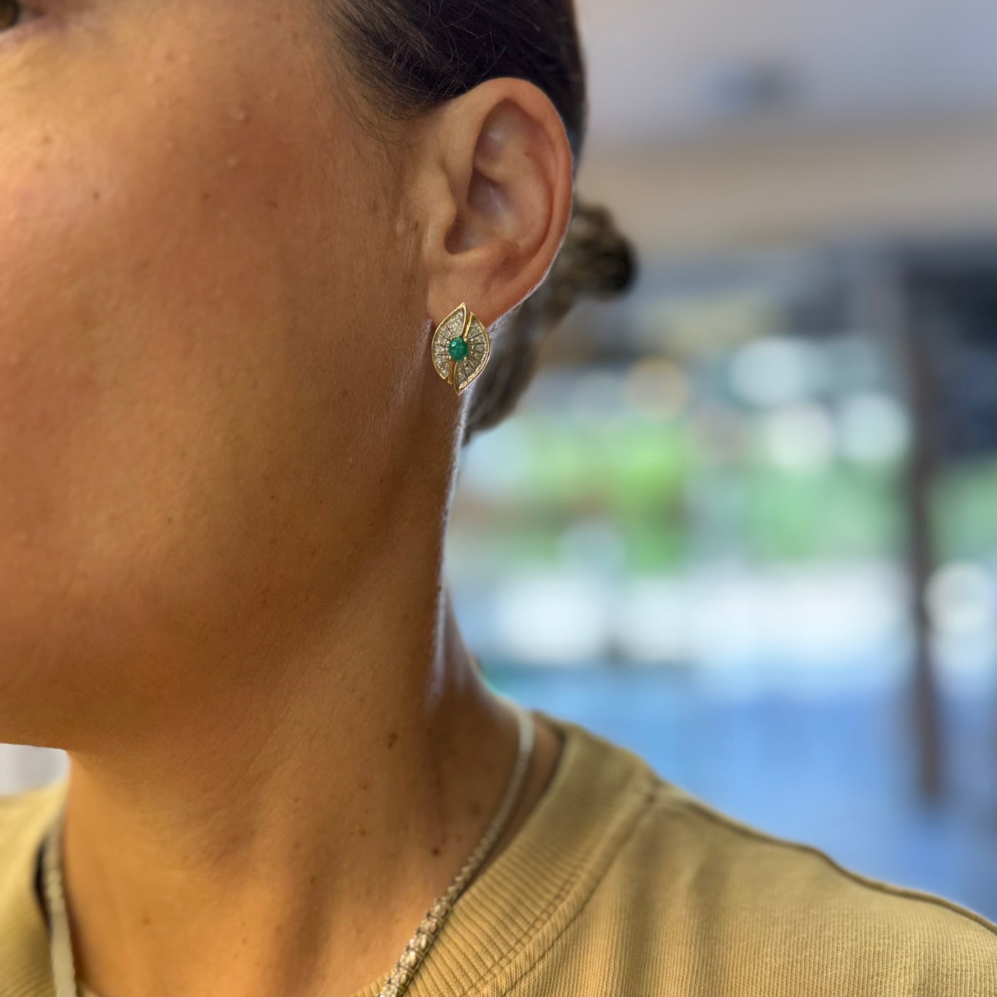 14K gold drop earrings in a refined leaf design, set with vivid green Emeralds at the center and shimmering pavé-set Diamonds along the curves