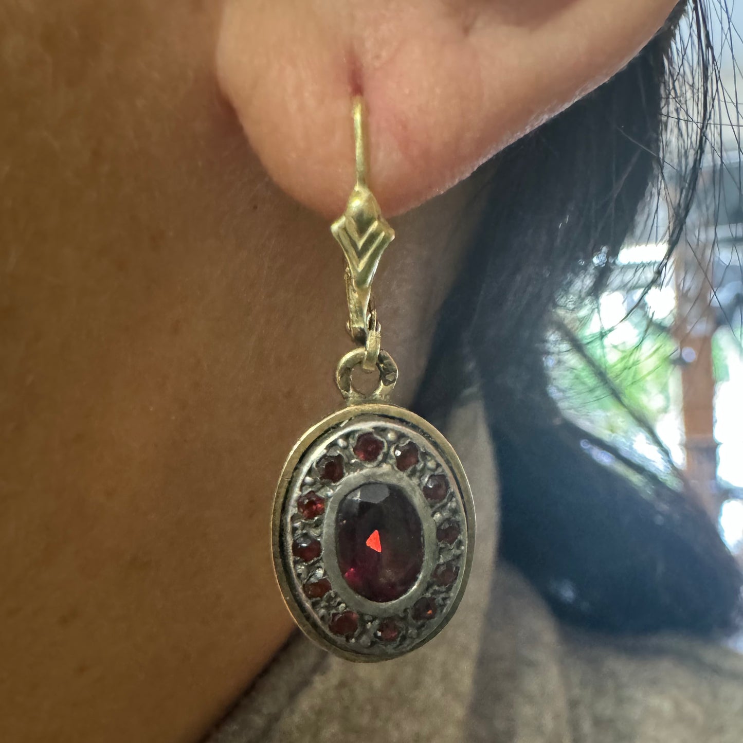 14K gold drop earrings set with deep red oval Garnets surrounded by smaller stones Garnets.