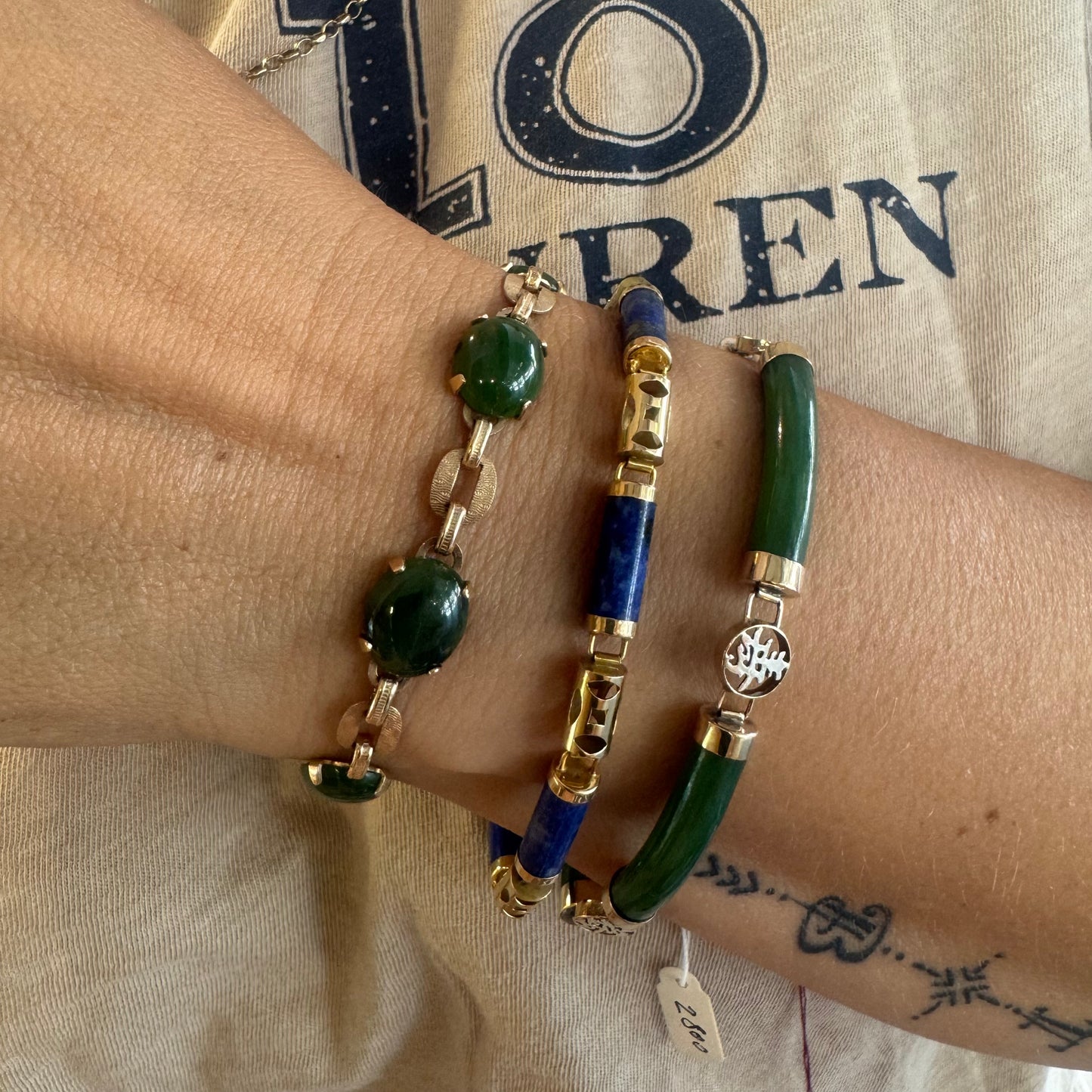 18K gold bracelet set with green Jade stones and accented with traditional Asian-inspired gold motifs