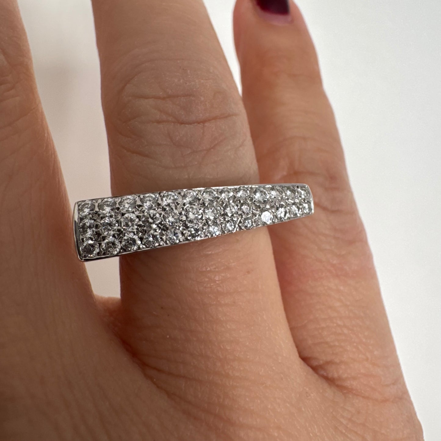 18K white gold band fully set with pavé diamonds across the surface.