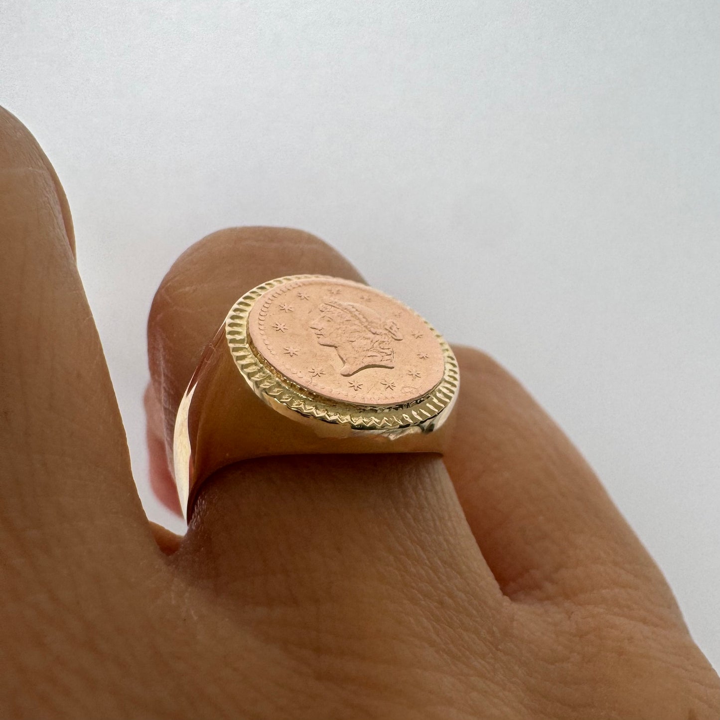 18K gold coin ring set with an authentic 22K gold coin at the center.