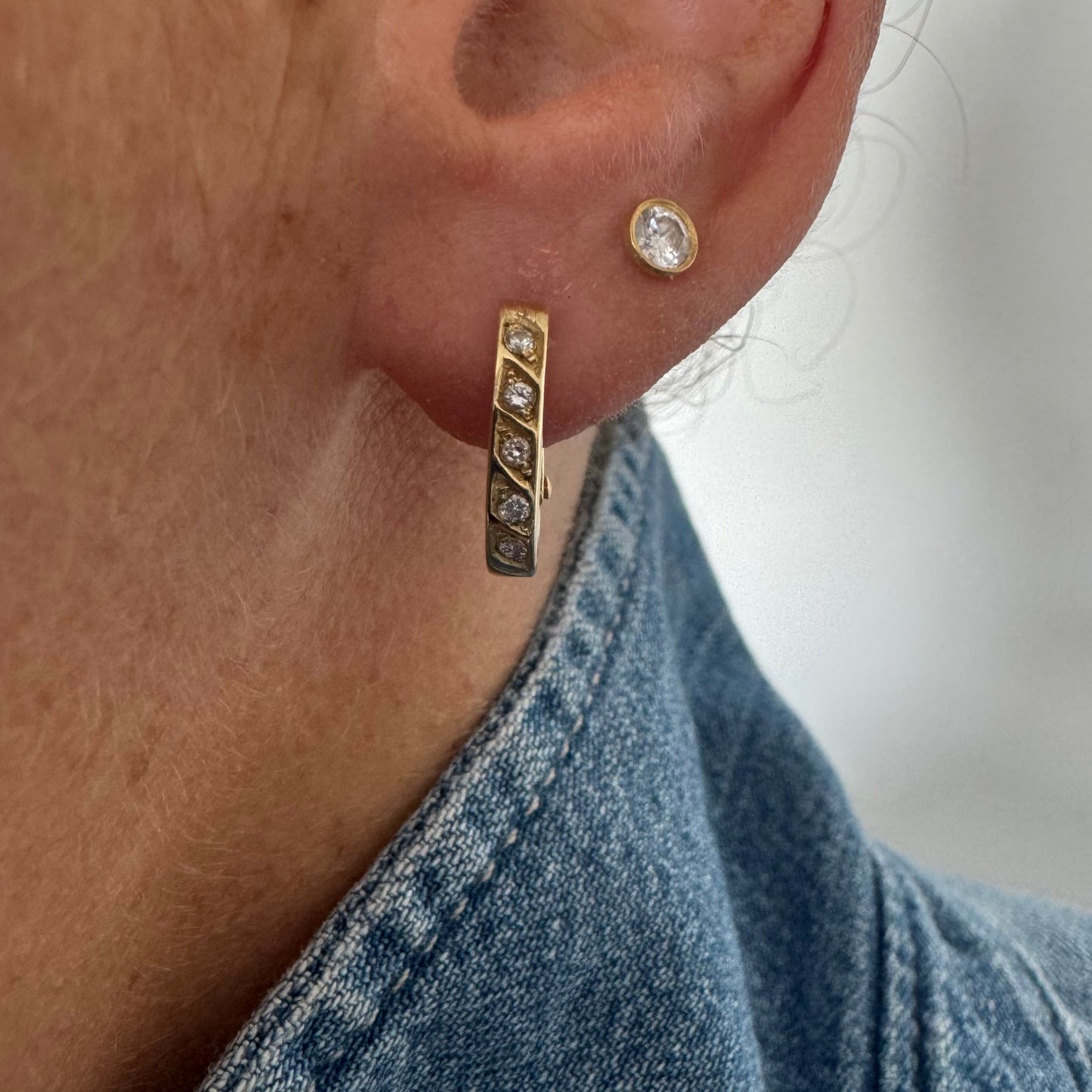 14K gold huggie earrings accented with a delicate row of sparkling Diamonds