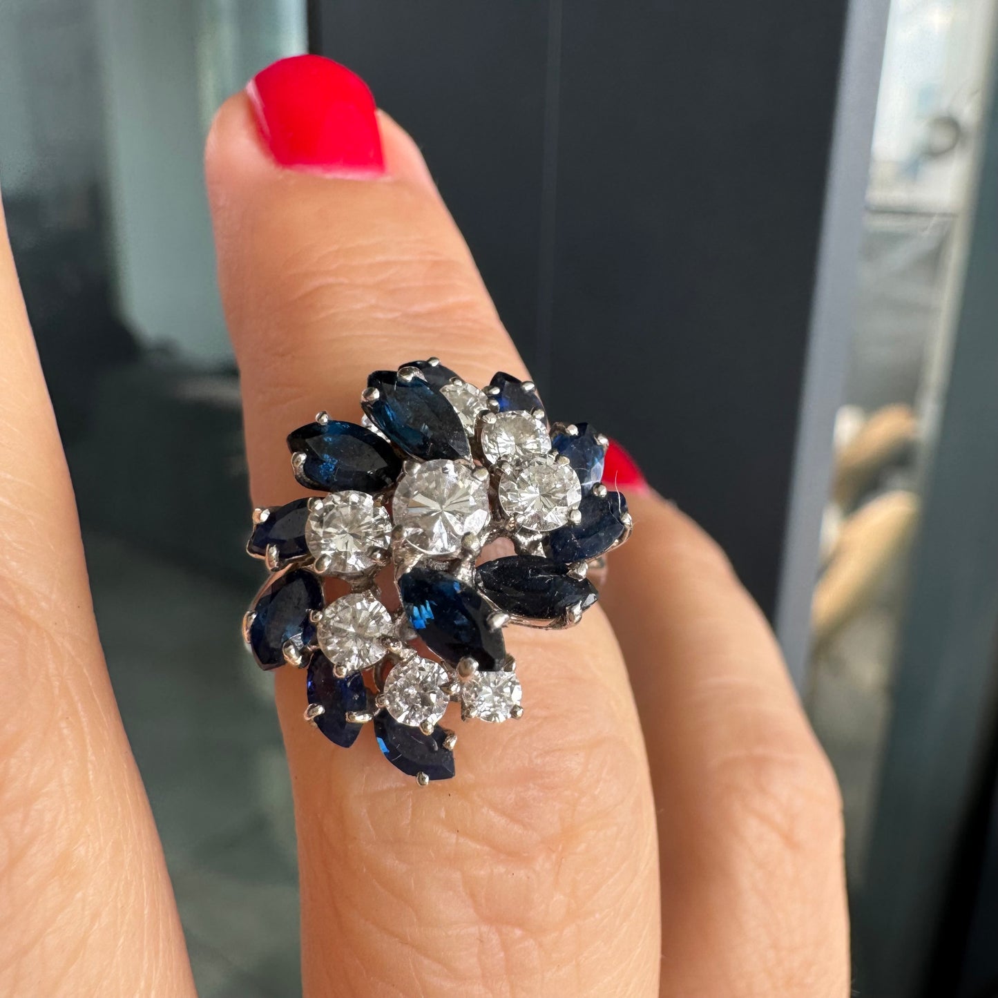 18K white gold ring, set with marquise-cut blue Sapphires and round Diamonds, in a classic cluster design.