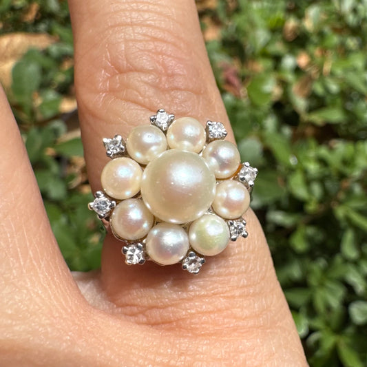 14K gold ring set with a floral cluster of lustrous Pearls in varying sizes, crowned by a central Pearl & surrounded by sparkling Diamond-like accents