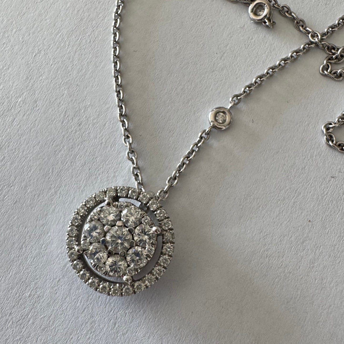 14K gold necklace featuring a round pendant set with a cluster of sparkling Diamonds