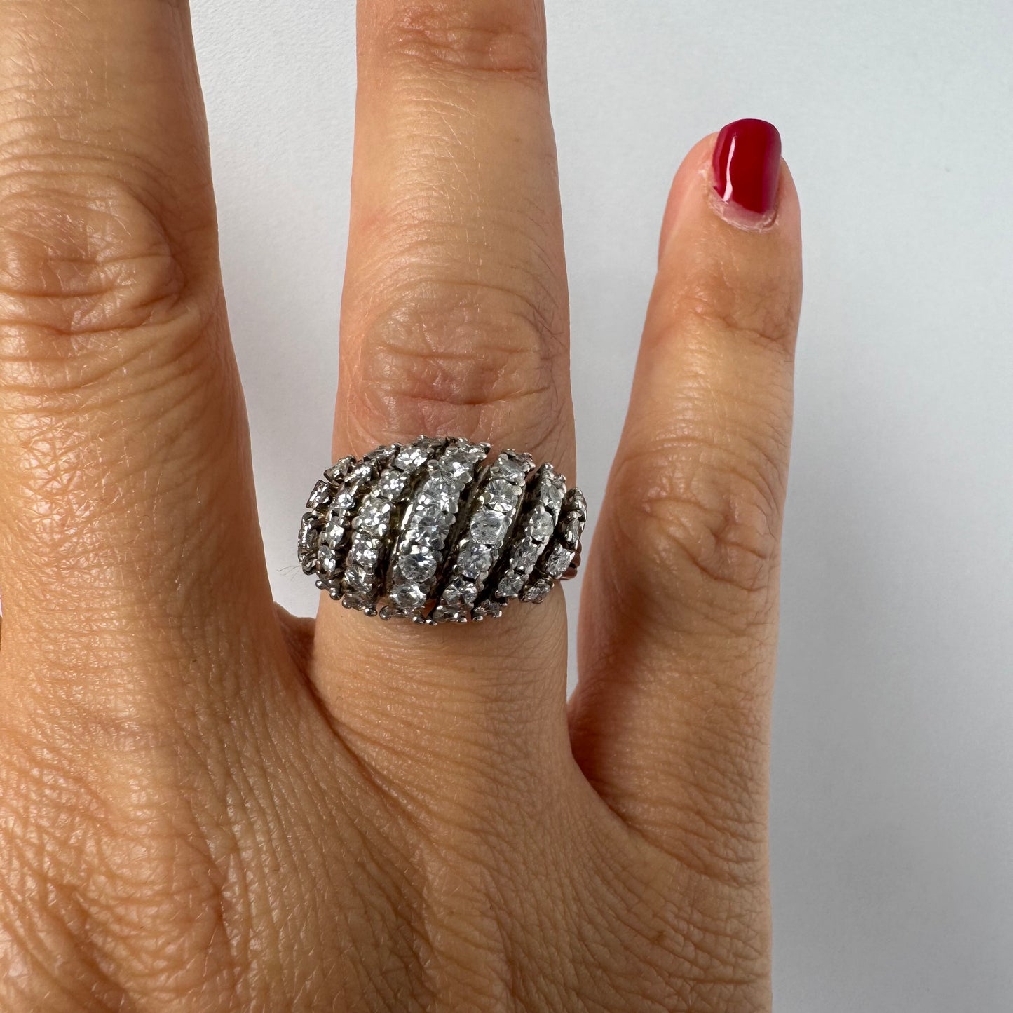 18K gold diamond ring with curved rows of brilliant stones.