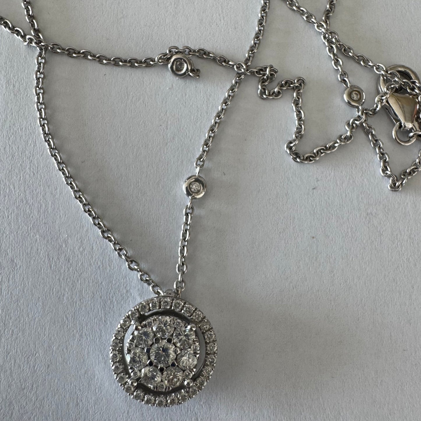 14K gold necklace featuring a round pendant set with a cluster of sparkling Diamonds
