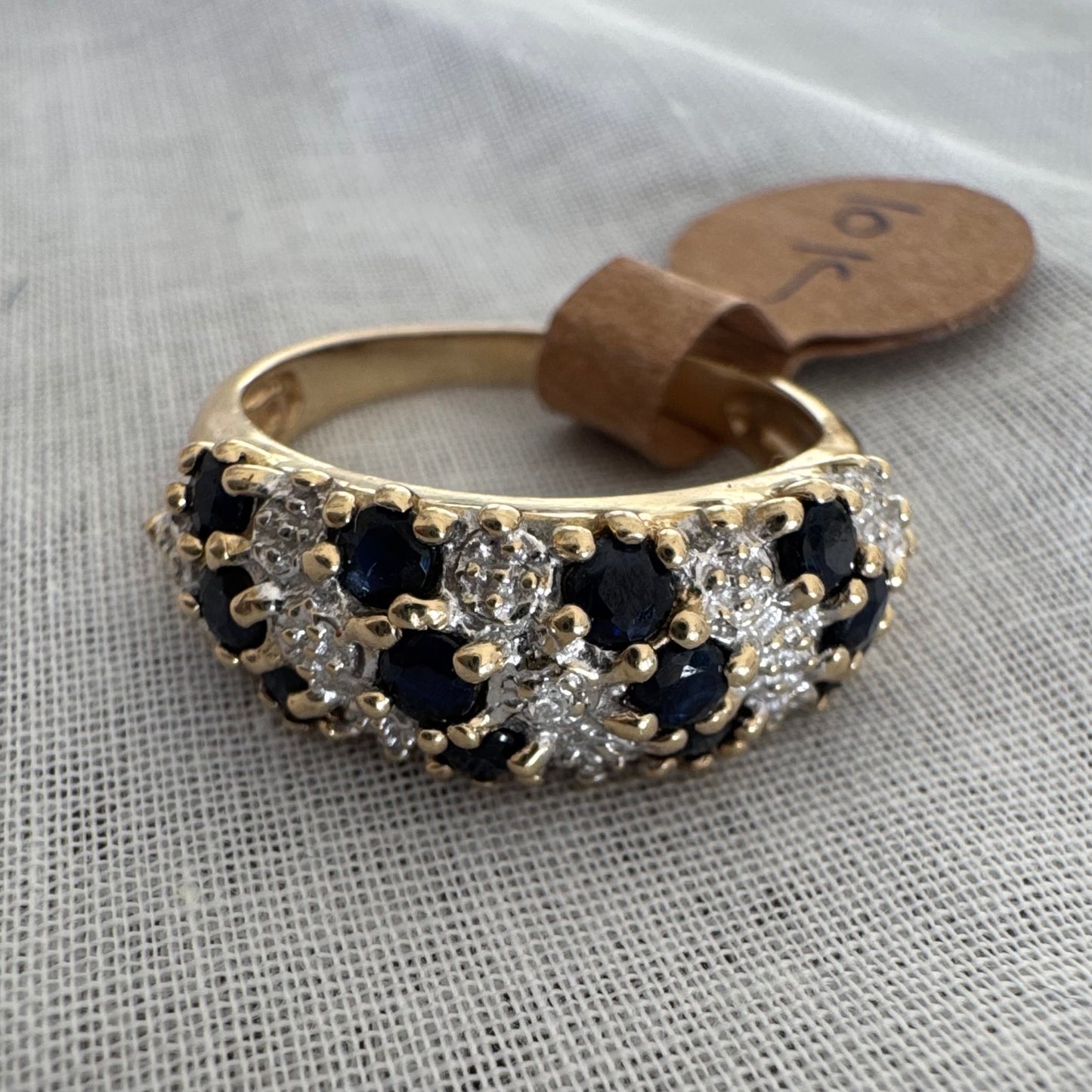 10K gold ring set with deep blue Sapphires and Diamonds in a classic, romantic design.