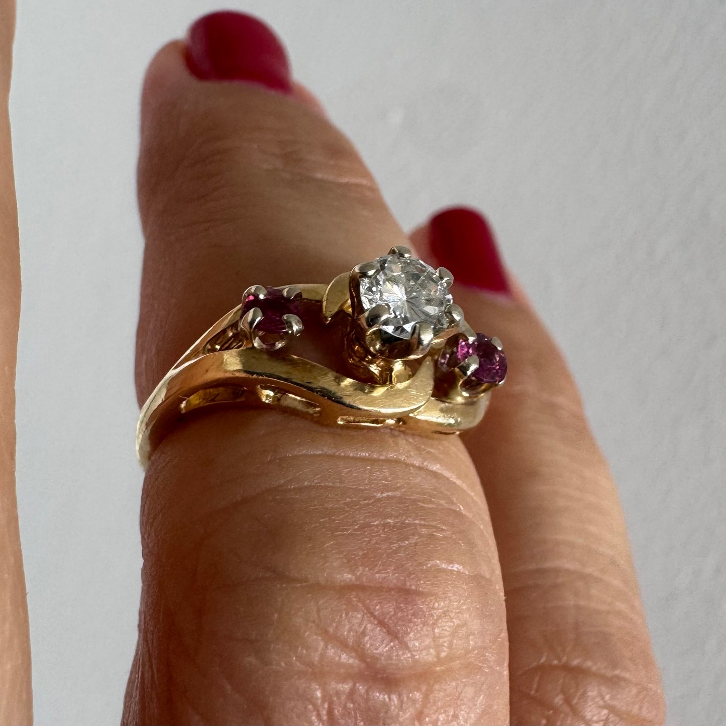14K gold ring set with a sparkling central Diamond & Ruby side stones