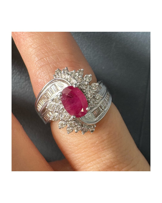 14K gold ring set with an oval Ruby
Surrounded by diamonds