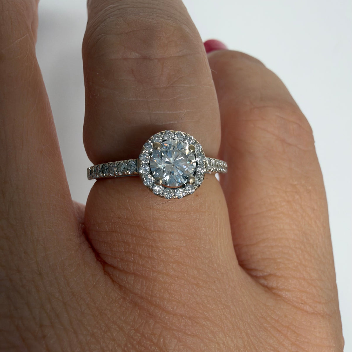14K white gold vintage ring with a round brilliant-cut diamond and diamond halo