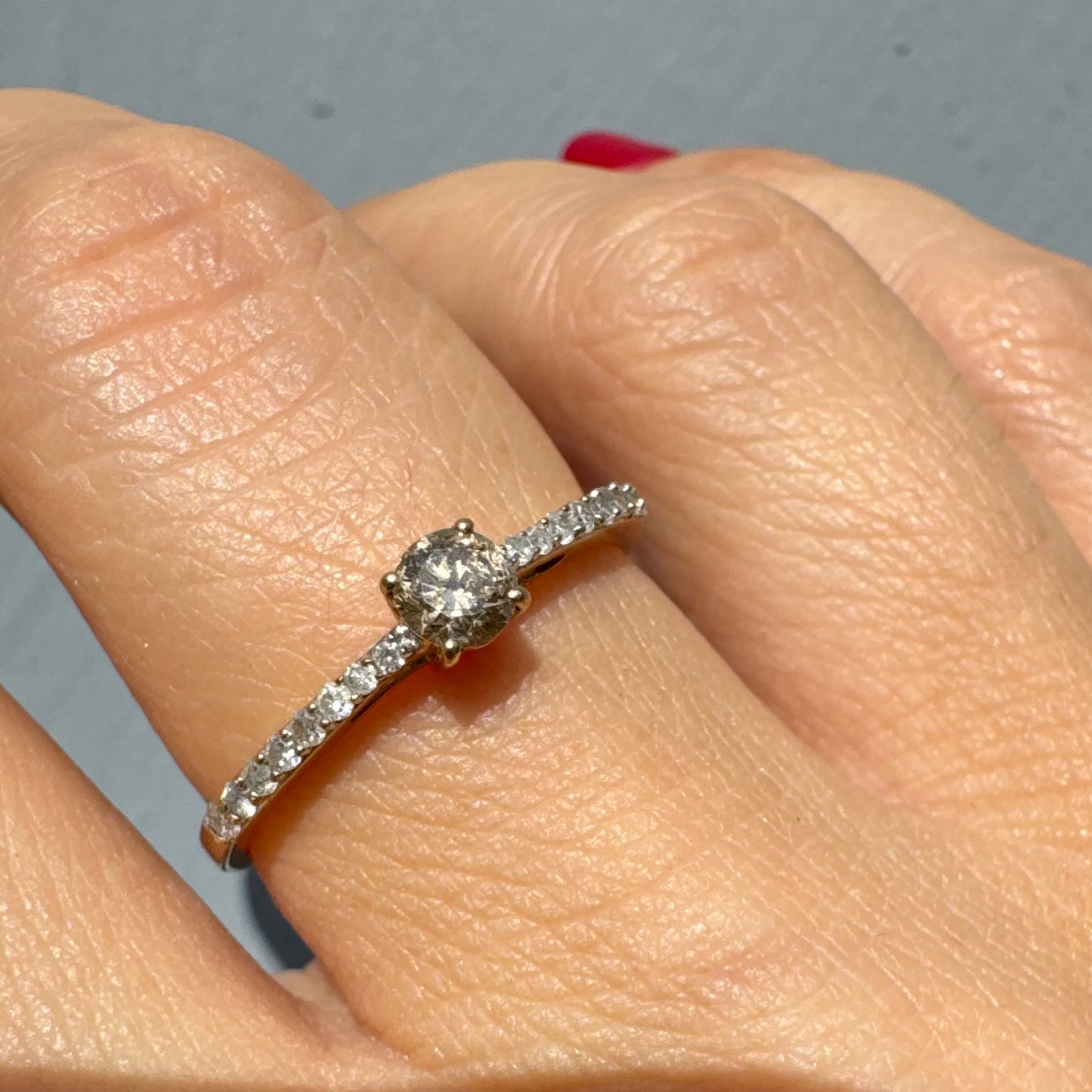 9K gold ring set with a central Diamond and sparkling Diamonds along the band