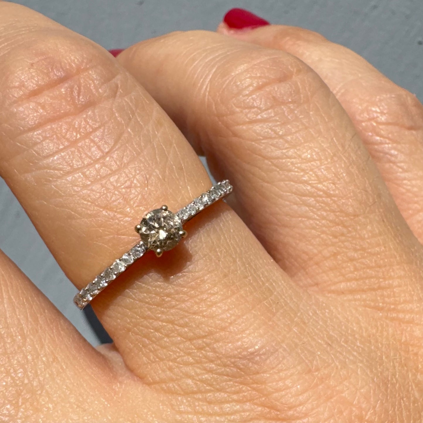 9K gold ring set with a central Diamond and sparkling Diamonds along the band