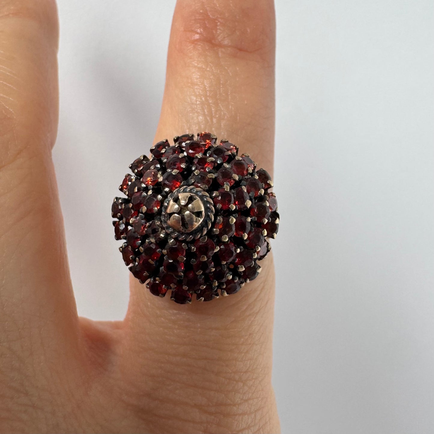 10K gold statement ring designed as a bold floral cluster set with Garnets
