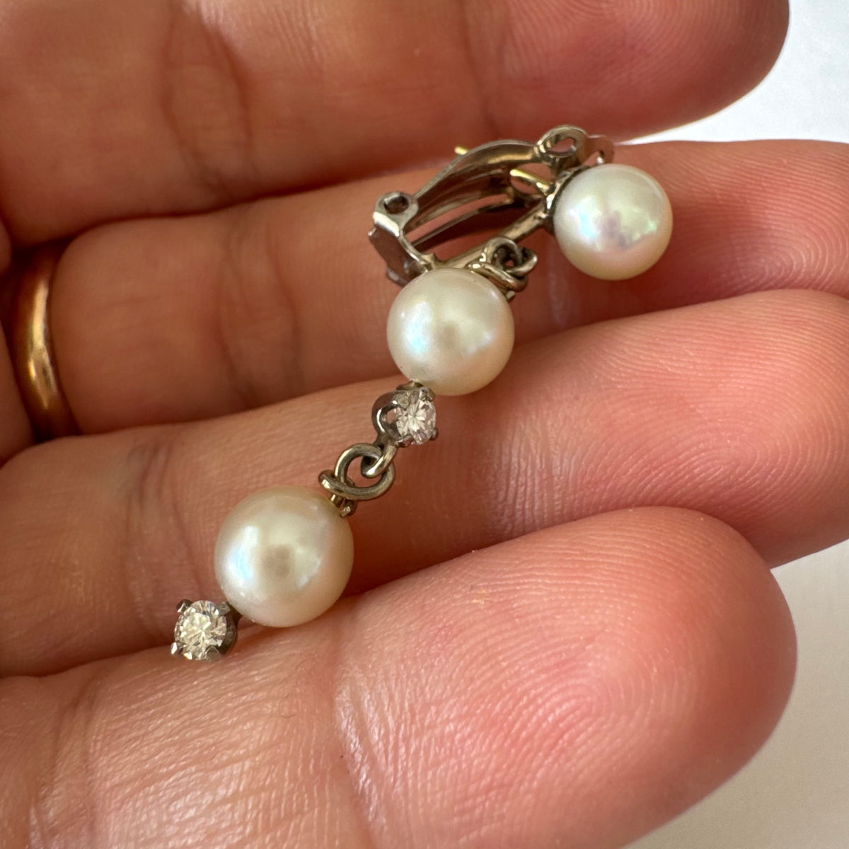 14K gold elegant drop earring set with three soft creamy Pearls connected by round brilliant Diamonds
