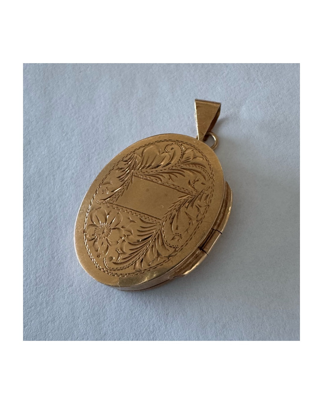 14K gold oval locket pendant delicately hand-engraved with floral motifs