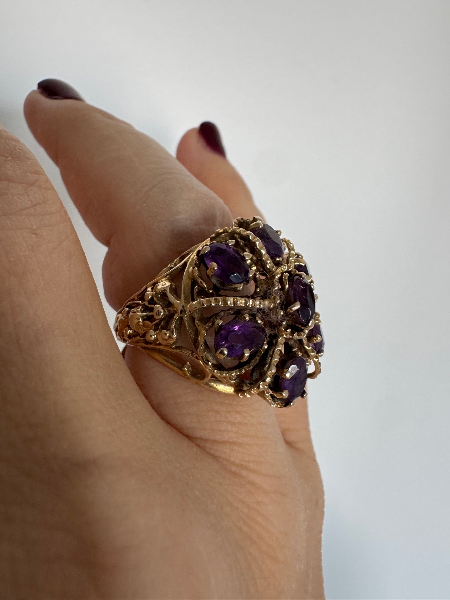 14K yellow gold cocktail ring set with a stunning cluster of Amethyst stones in marquise cuts.