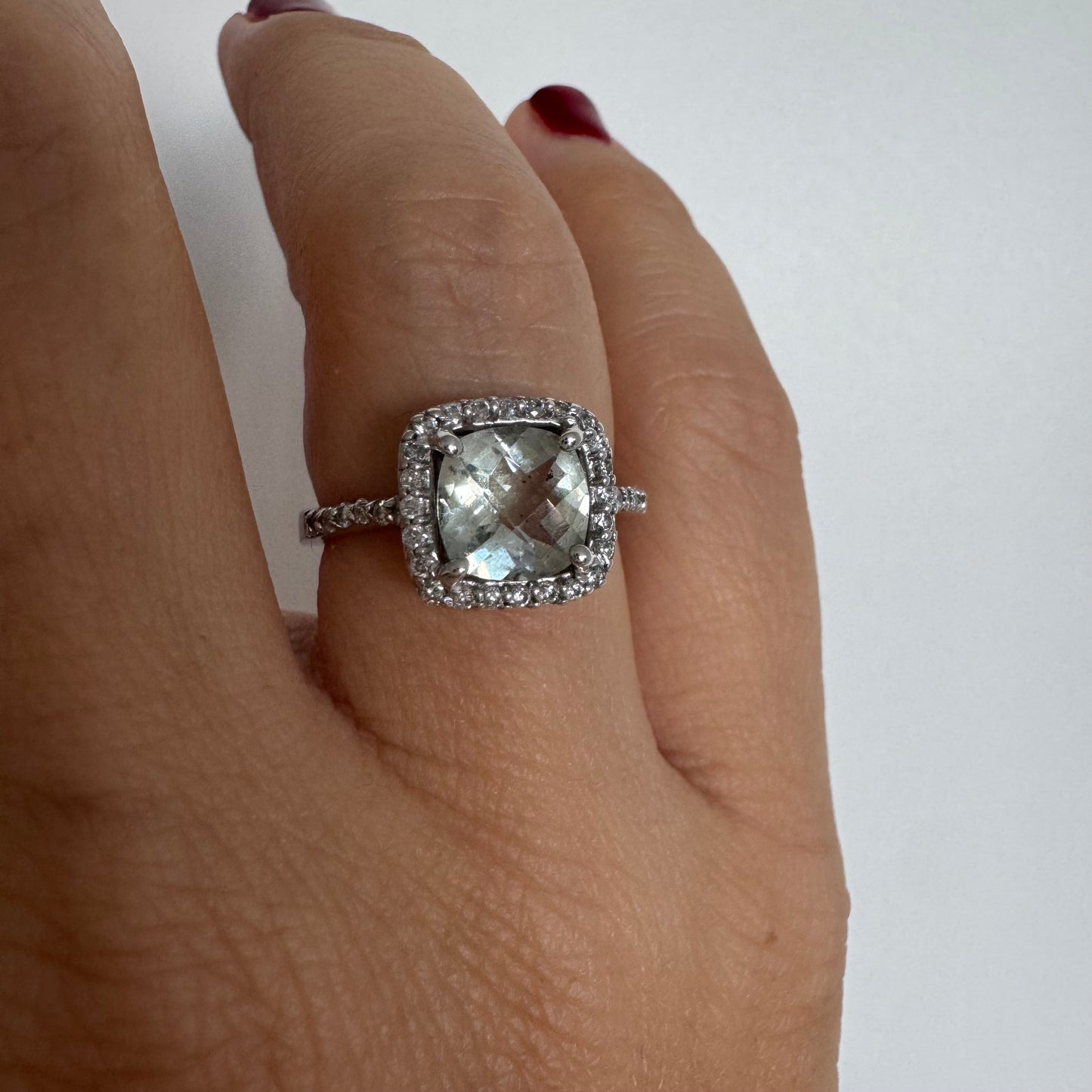 14K white gold ring featuring a cushion-cut light blue Aquamarine set in a sparkling double halo of round-cut Diamonds.