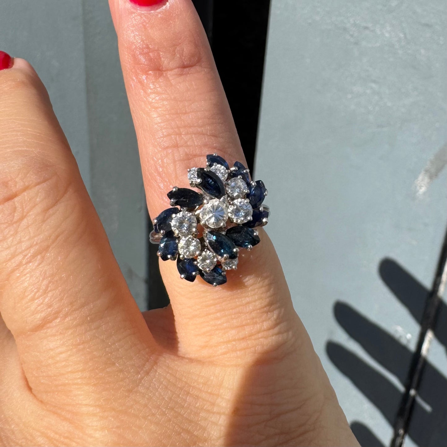 18K white gold ring, set with marquise-cut blue Sapphires and round Diamonds, in a classic cluster design.