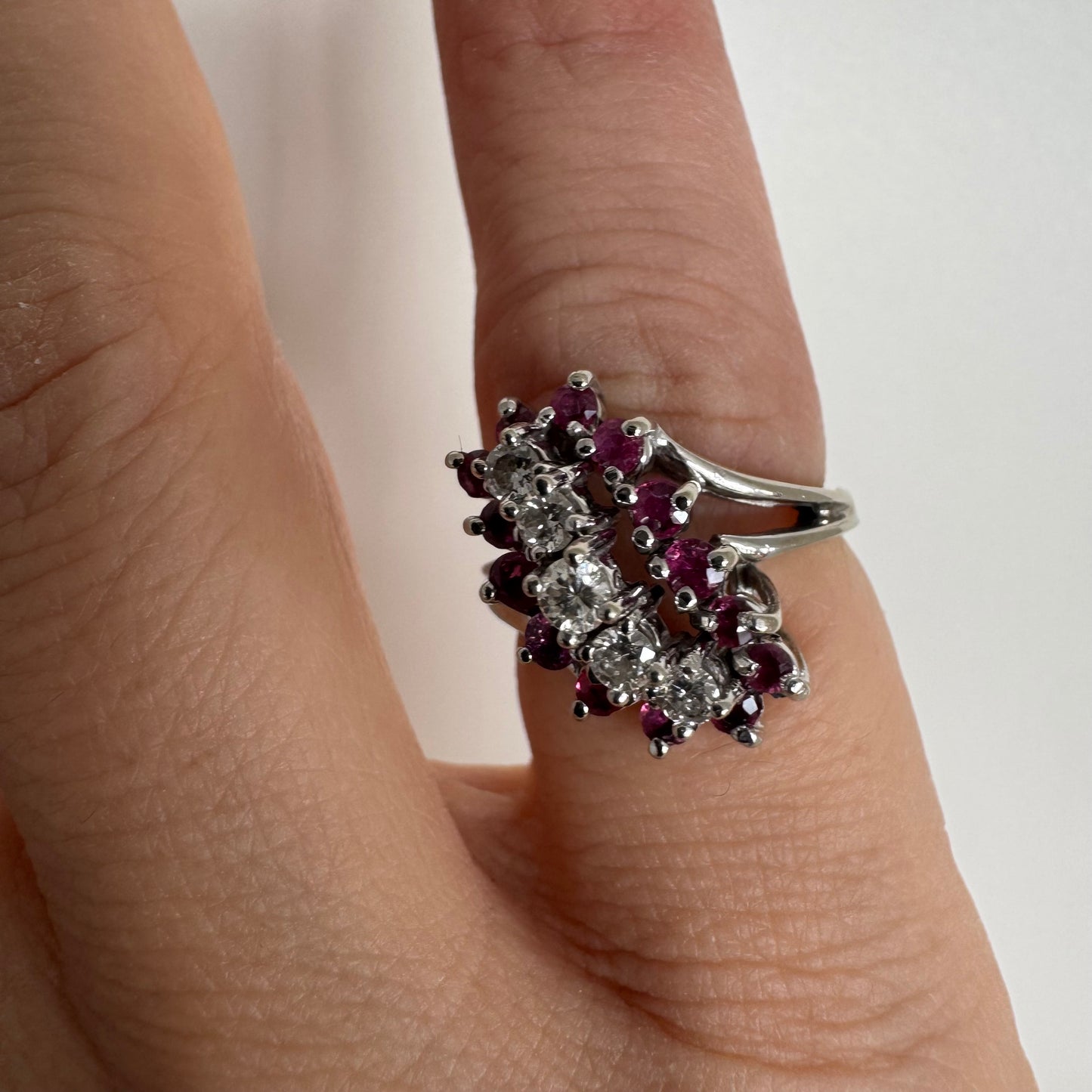 14K gold ring set with a rich cluster of deep raspberry-toned Rubies, centered by a vertical row of sparkling white Diamonds.