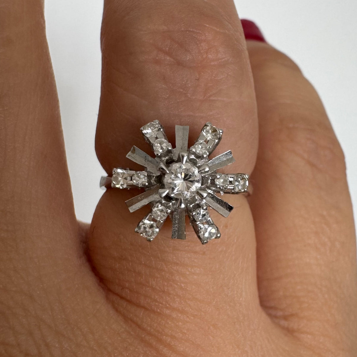 18K white gold ring designed as a radiant starburst, set with brilliant-cut diamonds that capture the light from every direction
