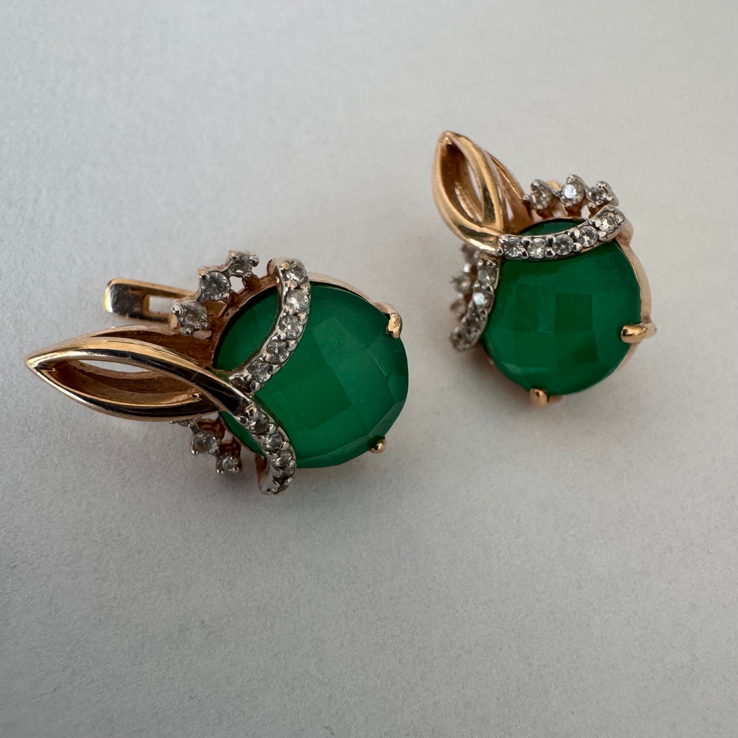 14K gold earrings set with vibrant green stones